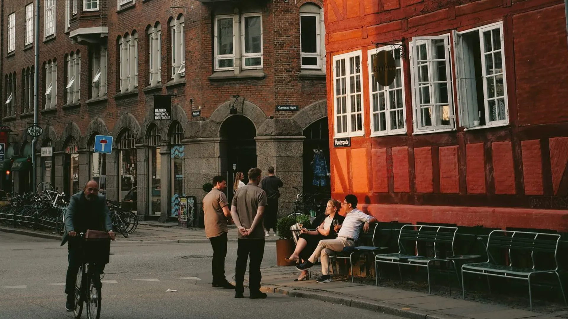 People enjoying a café on a historic street in Copenhagen, Denmark - Contiki Best of Scandinavia & The Baltics Tour