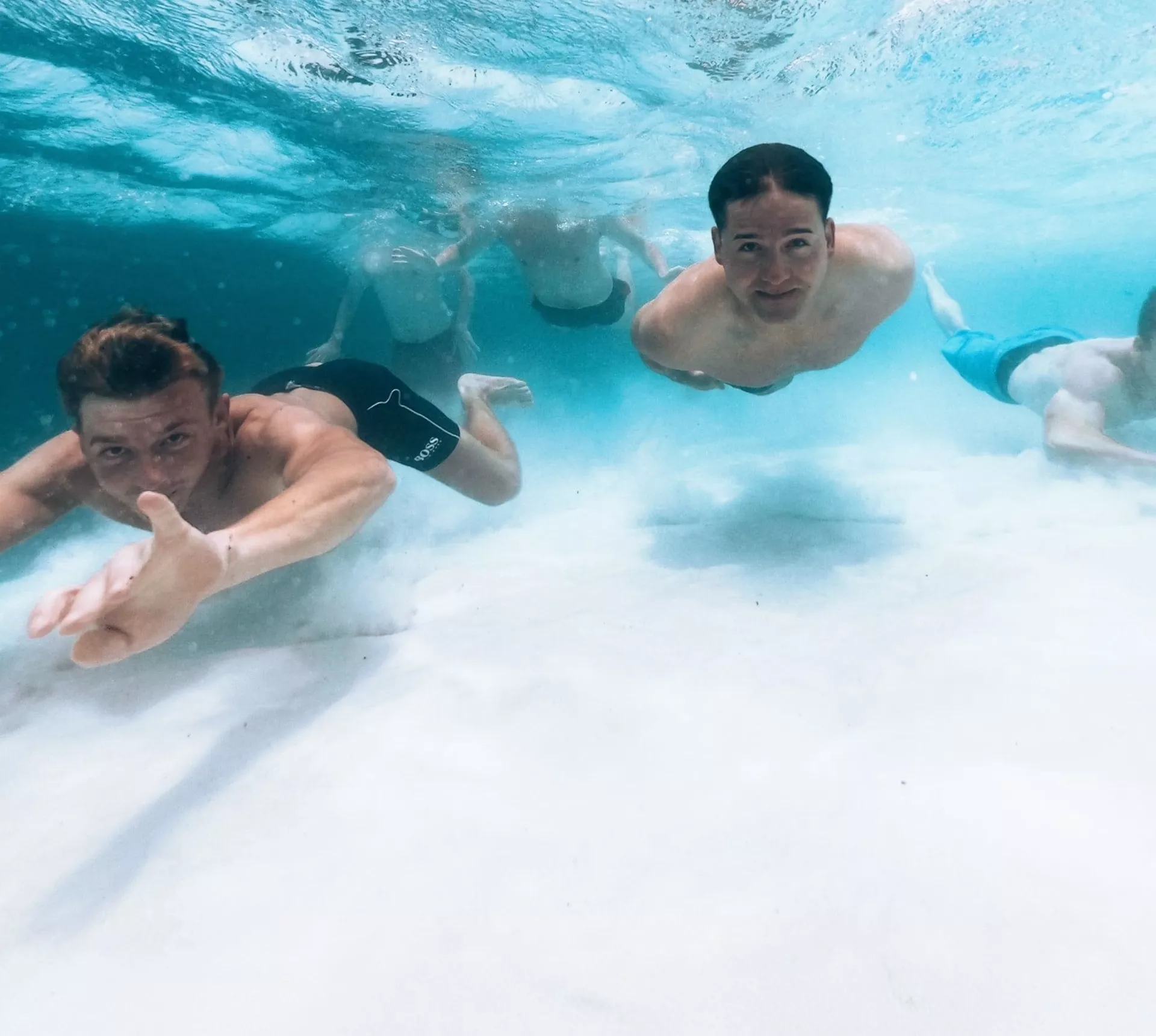 Beneath the surface of the Whitsundays, Contiki travellers swim through crystal-clear waters on the Whitsundays to Uluru Tour