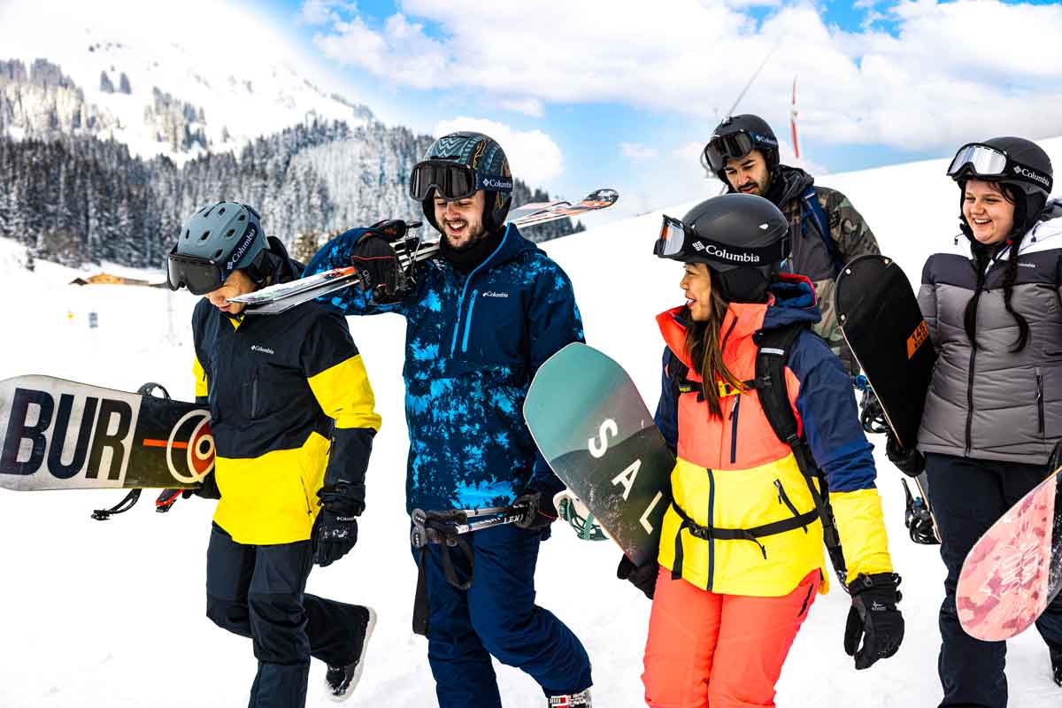 Group Of Skiiers Walking Down The Slope Talking In Austria