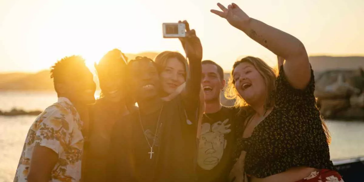 Group Taking Selfie At Sunset