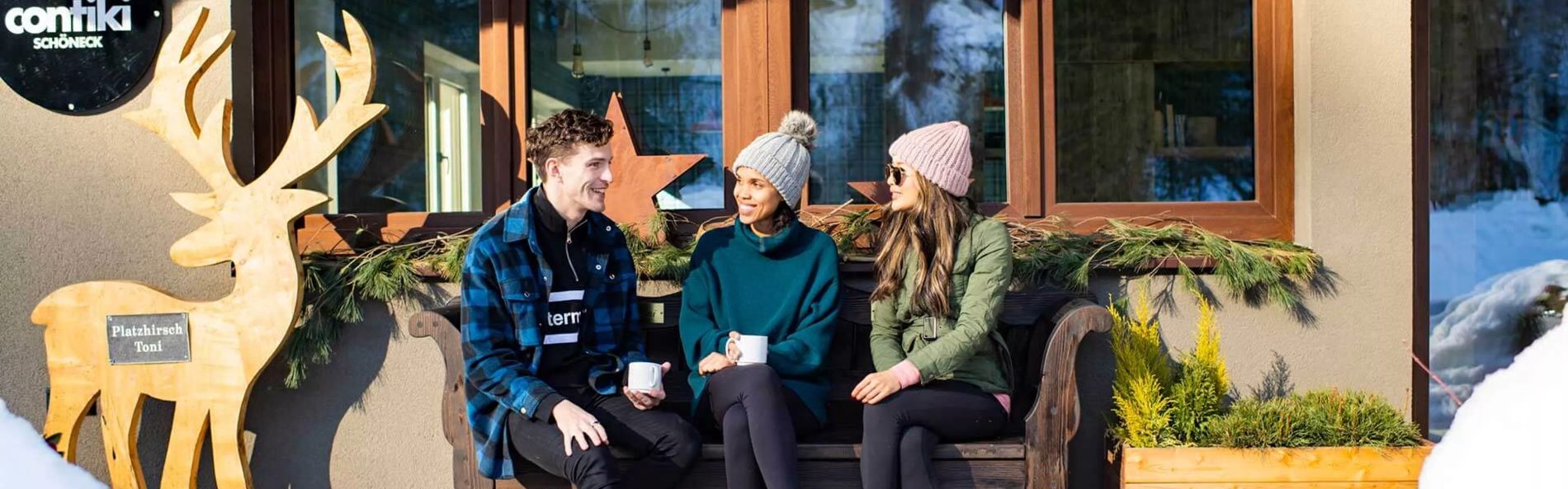Travellers Talking On A Bench Outside Contiki Schoneck