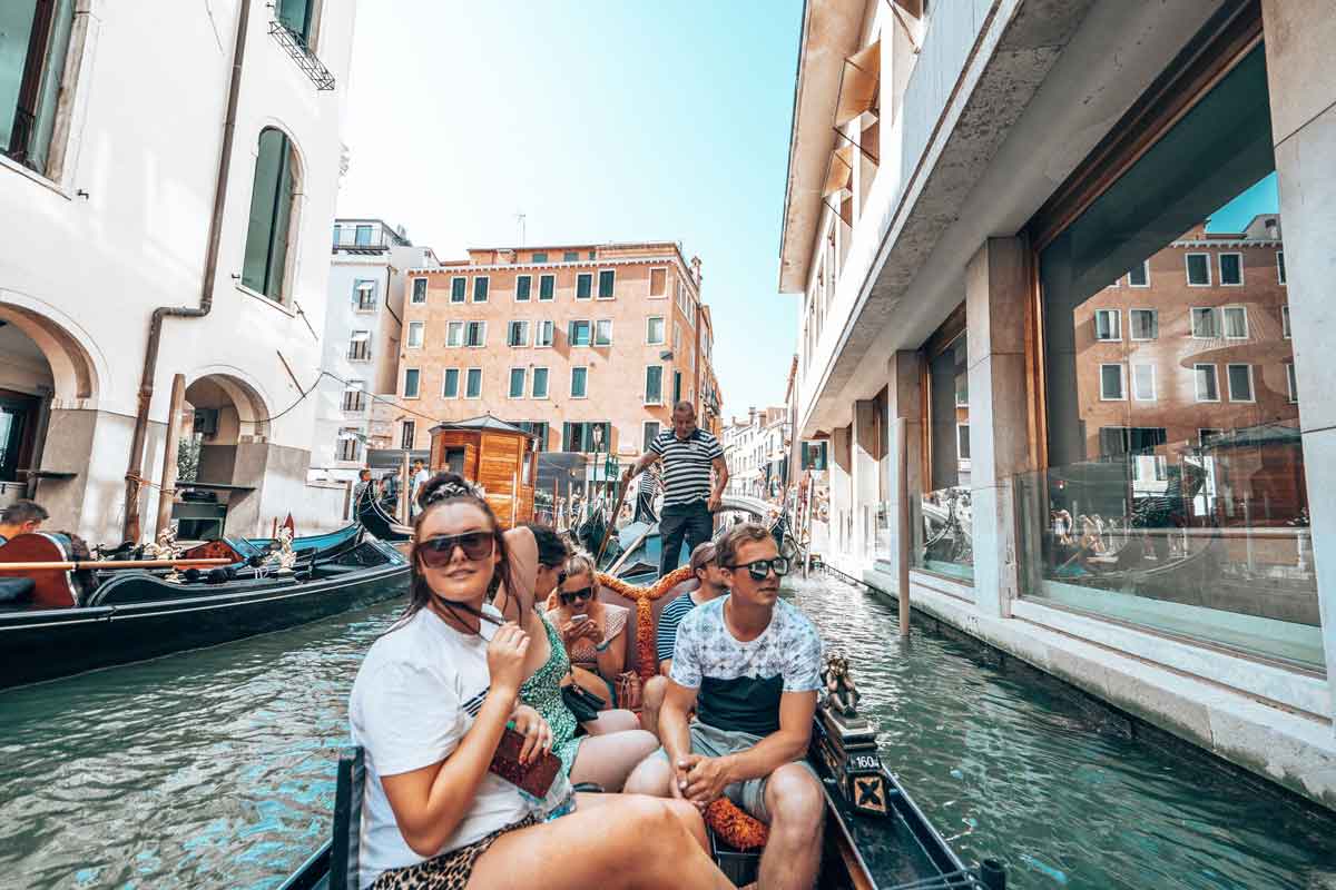 Group Of Happy Friends In A Boat In A Canal
