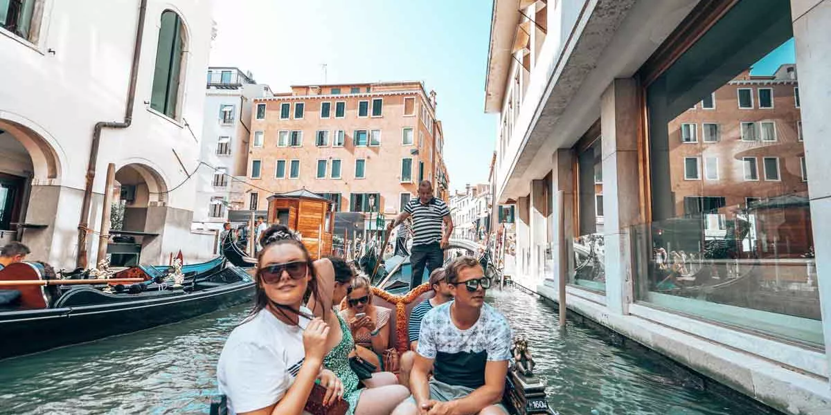 Group Of Happy Friends In A Boat In A Canal
