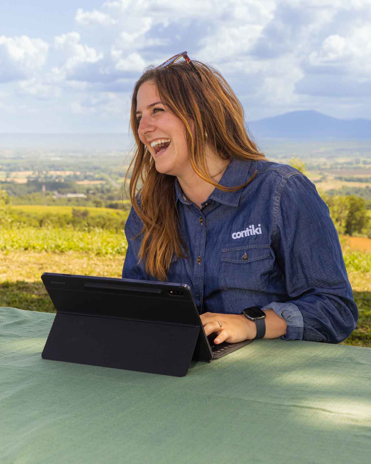 Contiki Team Member Smiling With Laptop
