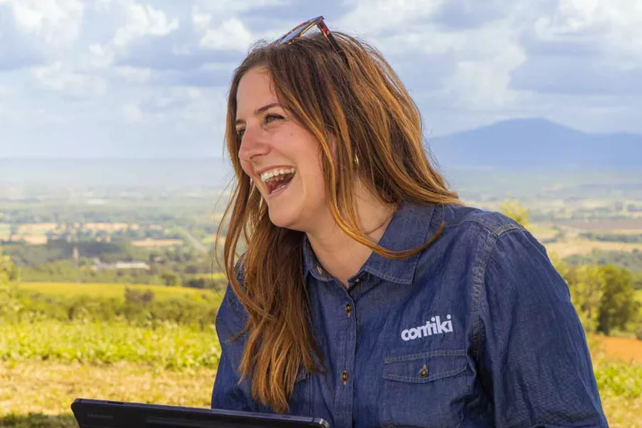 Contiki Team Member Smiling With Laptop