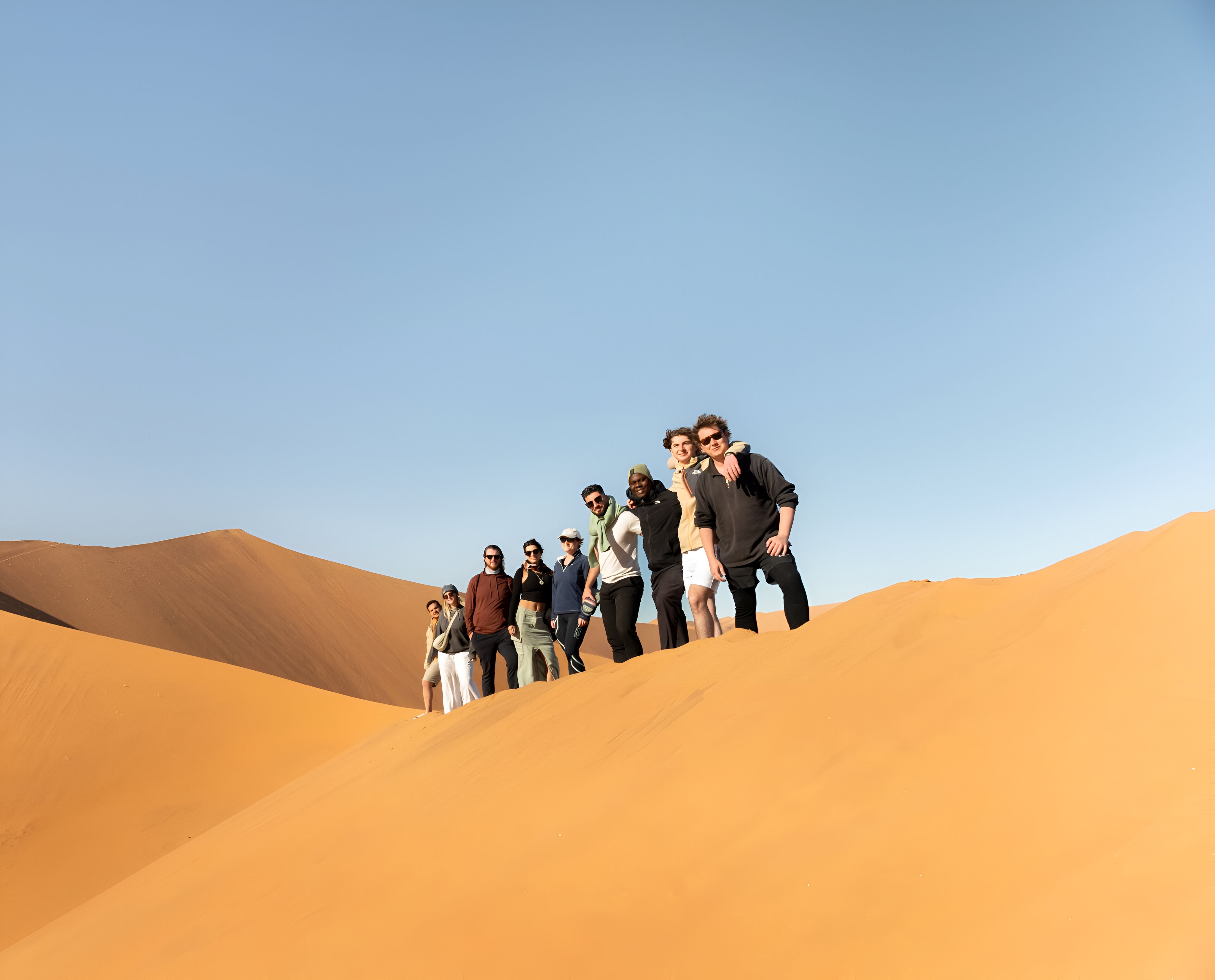 Namibian desert people standing on sand.
