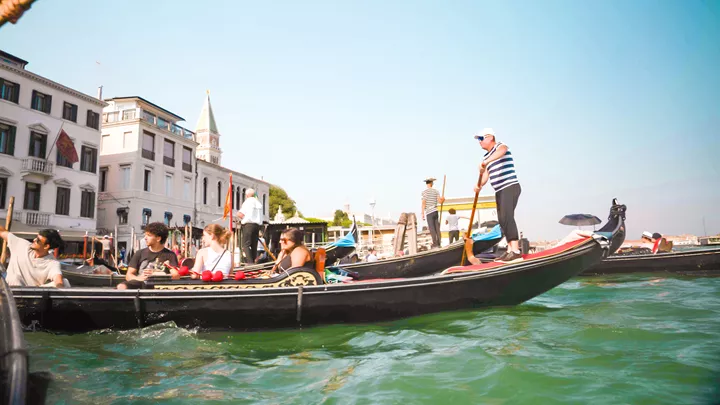 Travellers enjoying a gondola ride on the Venetian canals, Venice, Italy