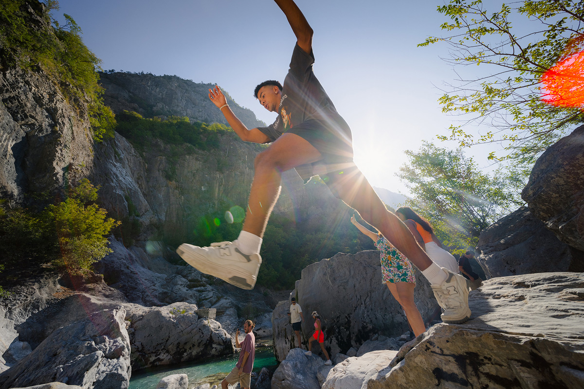 faq-tile-man-jumping-on-rocks-in-albanian-alps.jpg