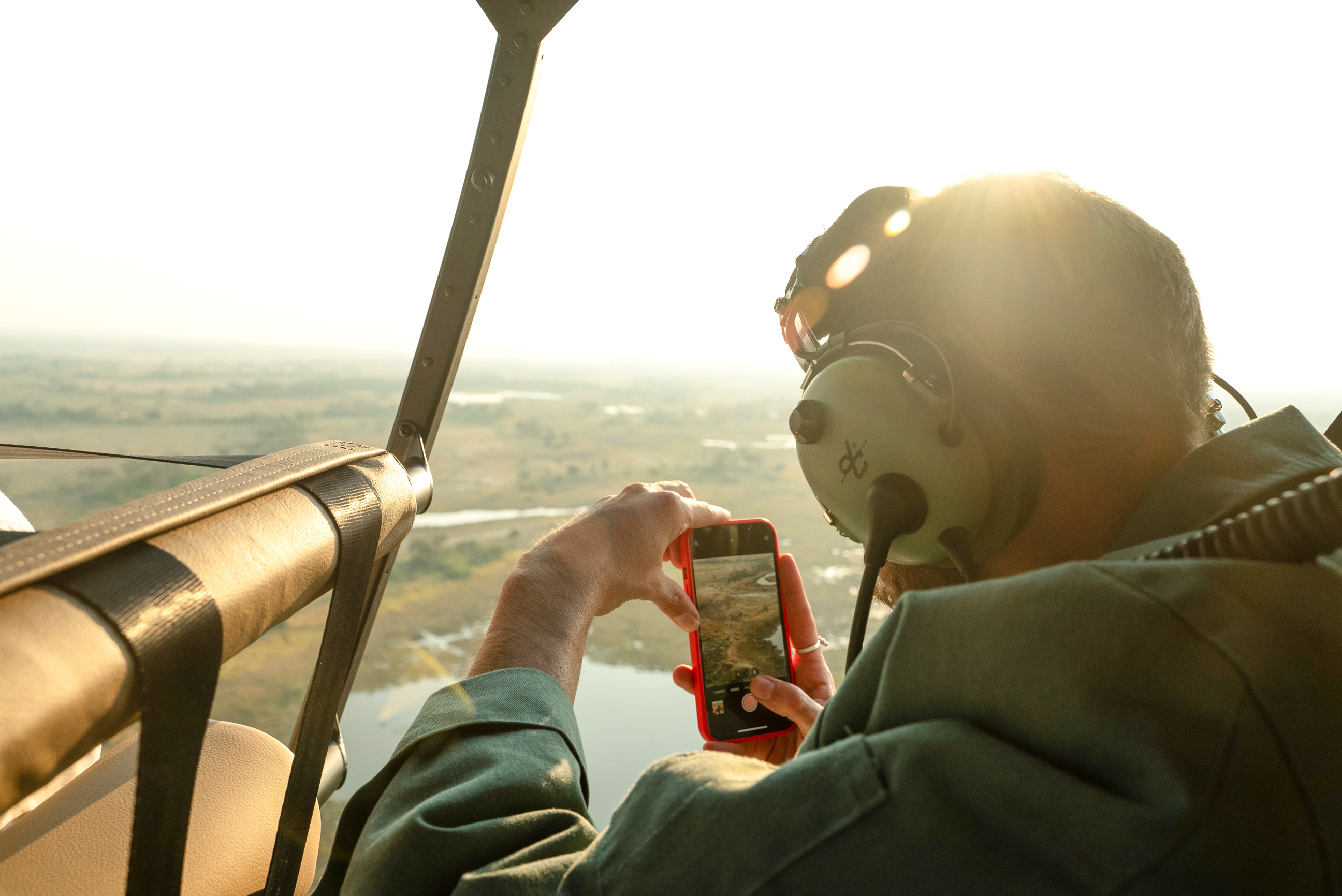 A traveller taking pictures from the helicopter ride in Botswana