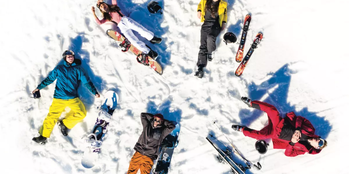 Group Of Young People Lying In Snow