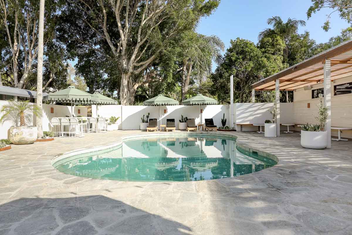 Small Swimming Pool Surrounded By Sunbeds And Umbrellas