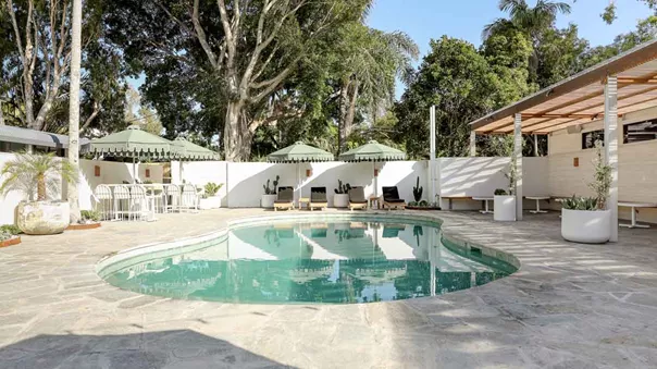Small Swimming Pool Surrounded By Sunbeds And Umbrellas