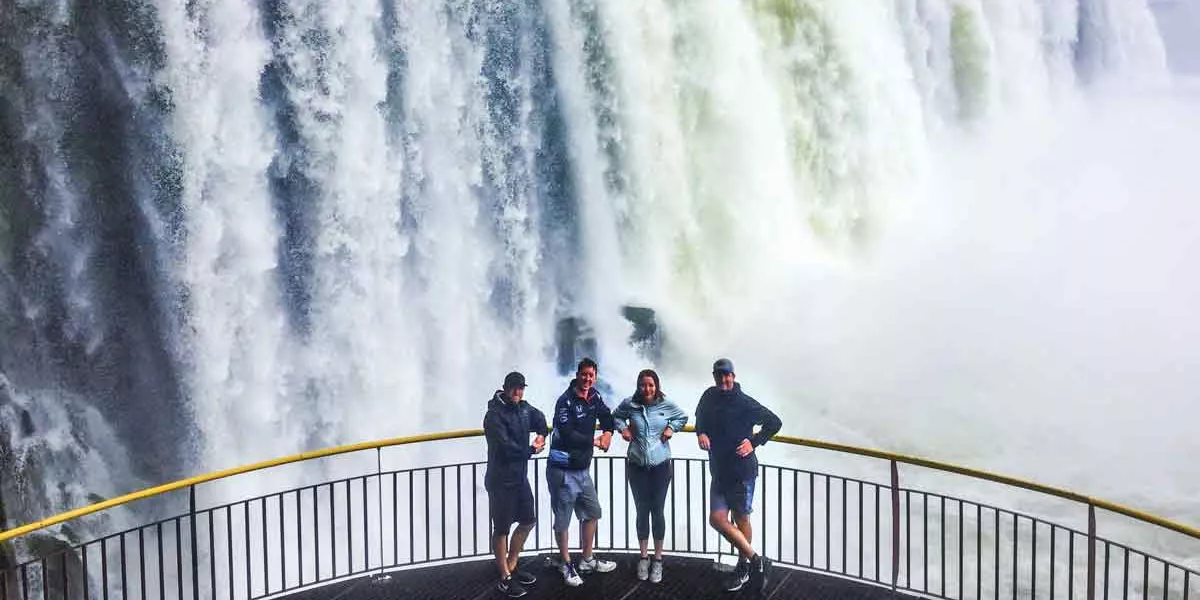 Group Of People Taking A Picture In Front Of Iguassu Falls
