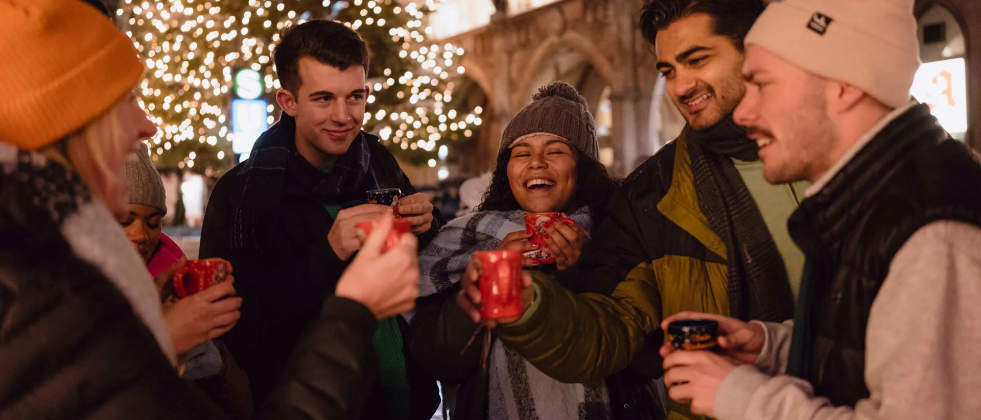 Group of friends enjoying mulled wine at Christmas market Group of friends enjoying mulled wine at Christmas market
