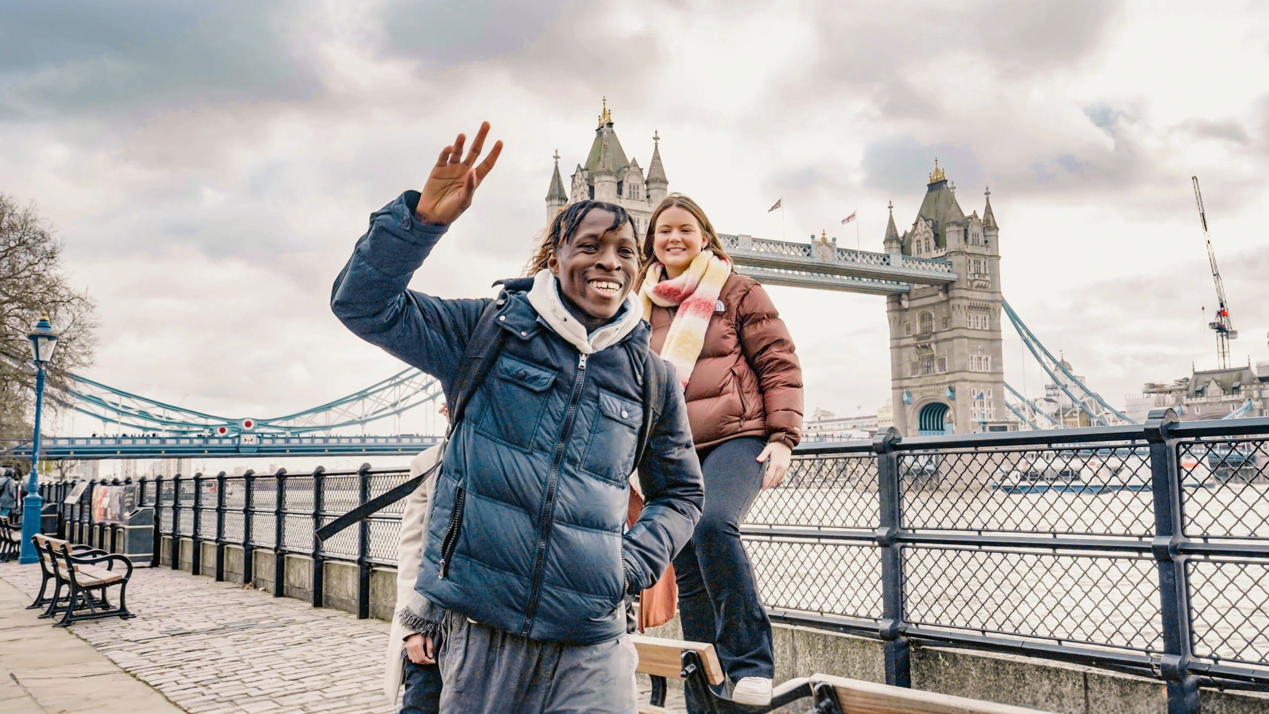 Contiki ravellers posing in front of Tower Bridge in London on Contiki's England in a Week Tour, exploring one of England's most iconic landmarks