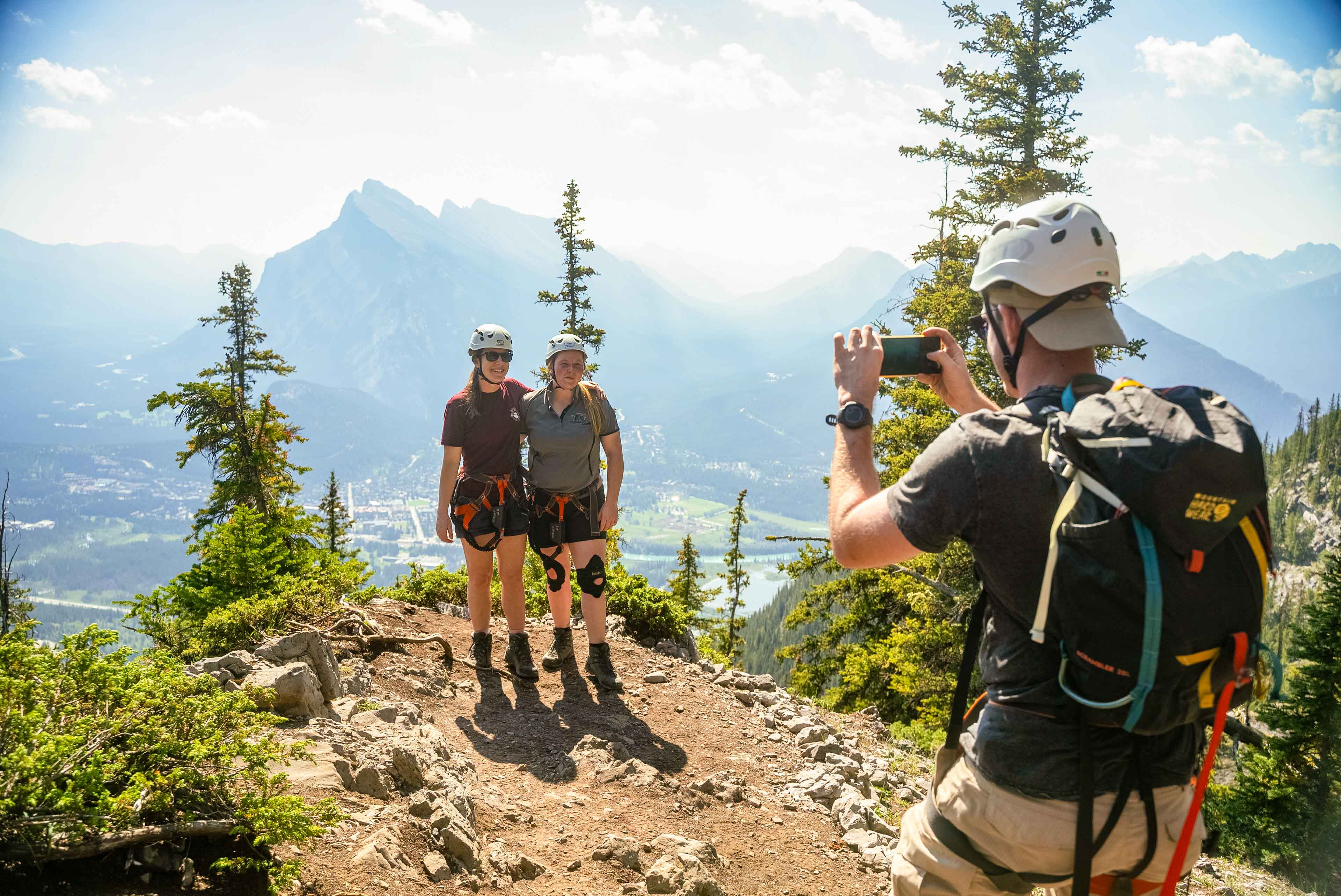 A group of adventurers taking a photo on a mountain in Canada.