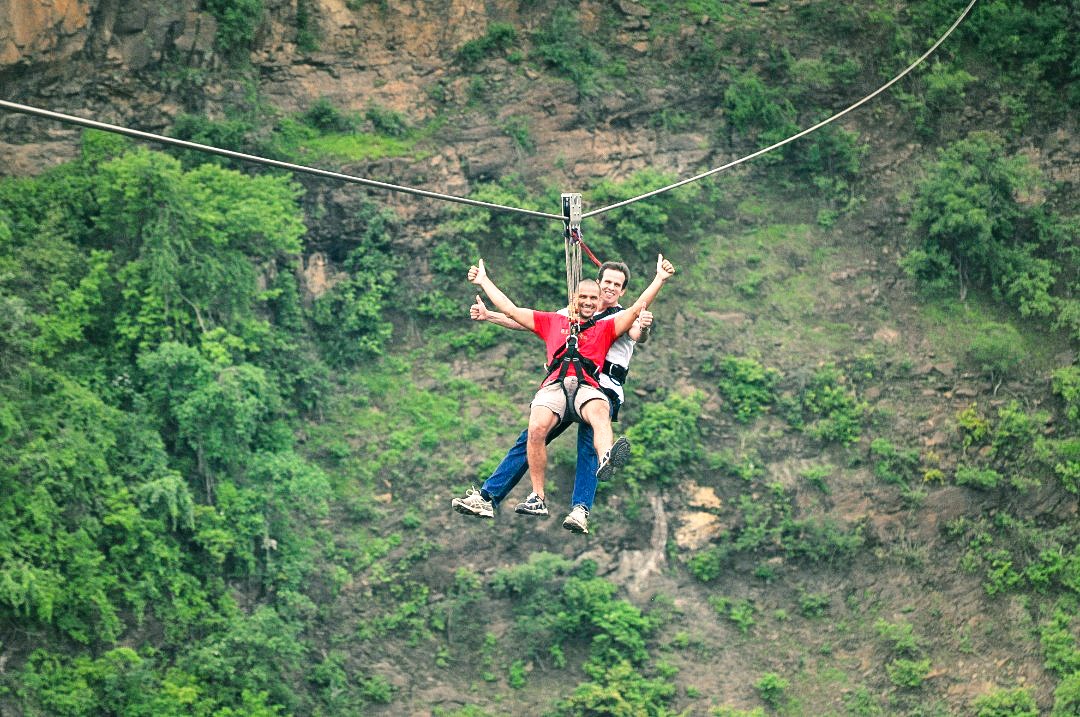 Travellers zipling across the gorge in Victoria Falls, Zimbabwe