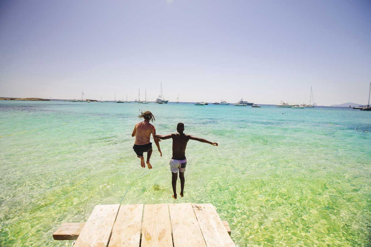 Two men jumping into the water