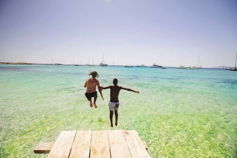 Two men jumping into the water