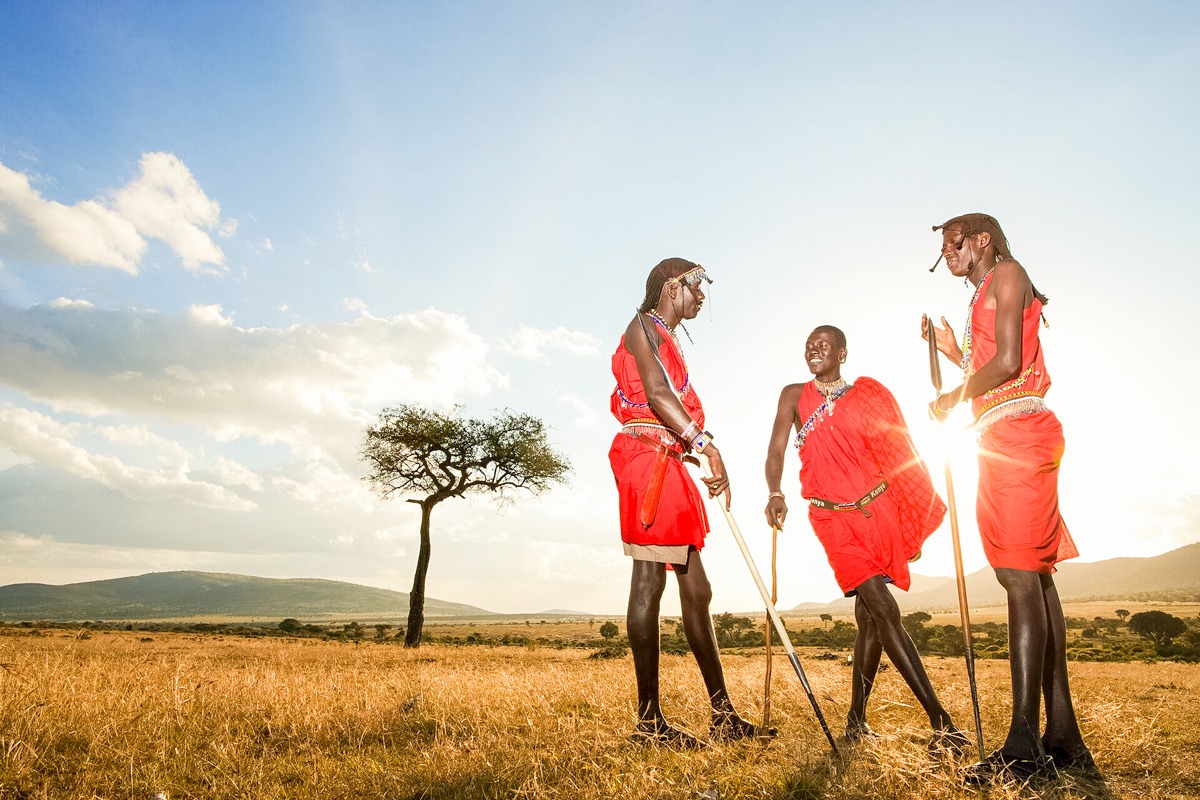 Three Maasai tribesmen talking to each other in Kenya.