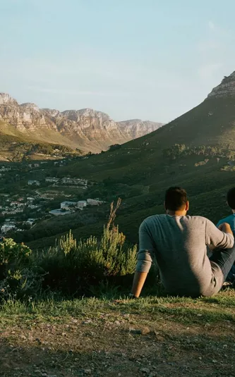 Travellers enjoy panoramic views of Table Mountain and Lion's Head overlooking Cape Town on the Contiki Cape Town, Safari & Falls Tour