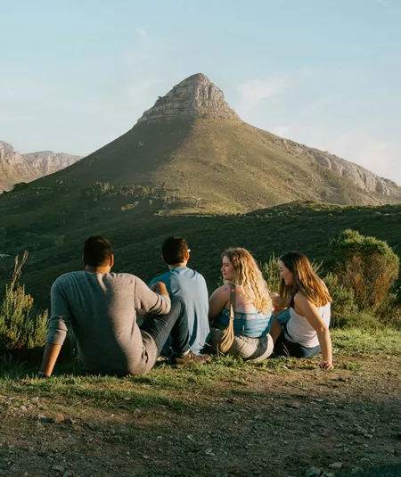 Travellers enjoy panoramic views of Table Mountain and Lion's Head overlooking Cape Town on the Contiki Cape Town, Safari & Falls Tour