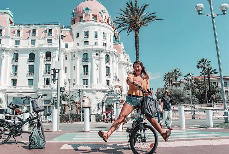 A smiling girl on a bicycle
