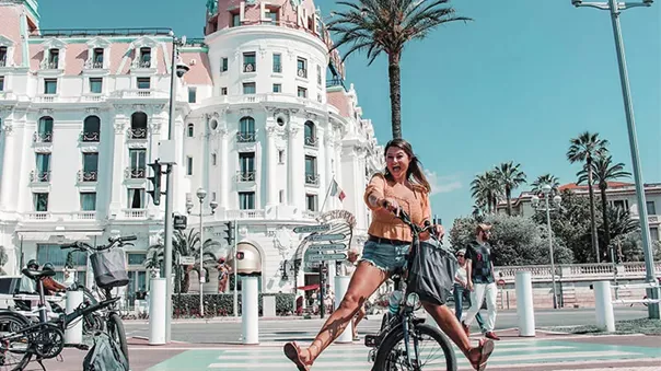 A smiling girl on a bicycle