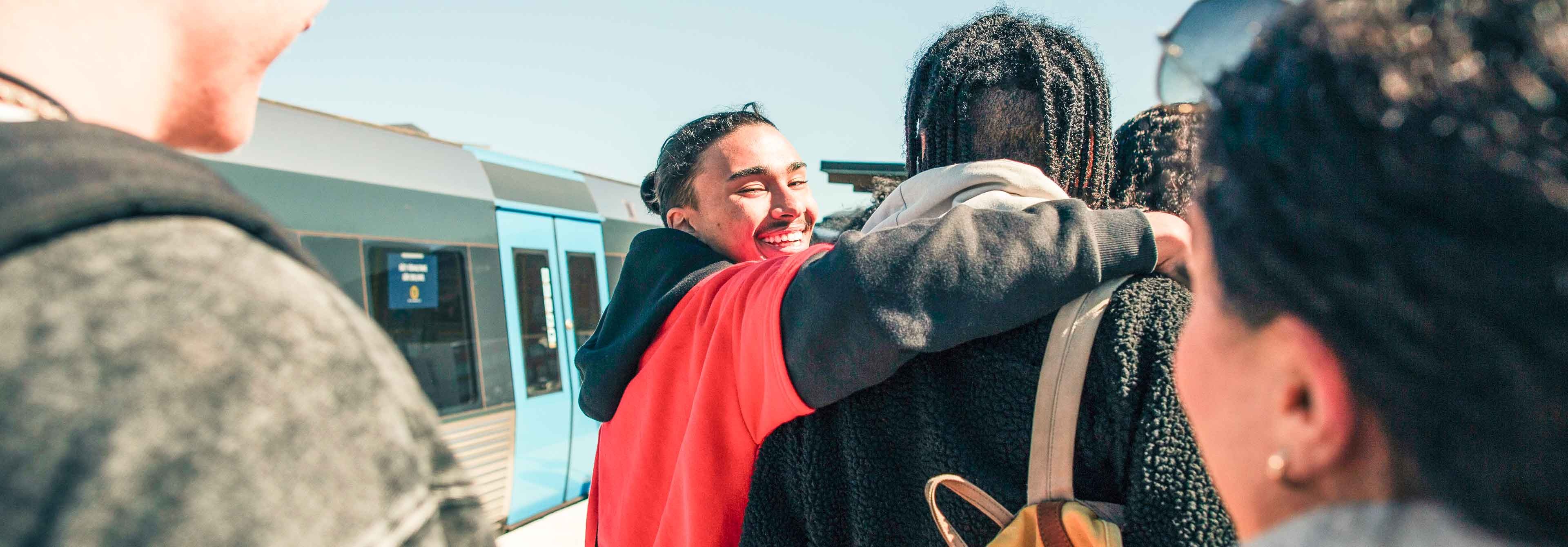 Group Of Young Travelers On Train Platform