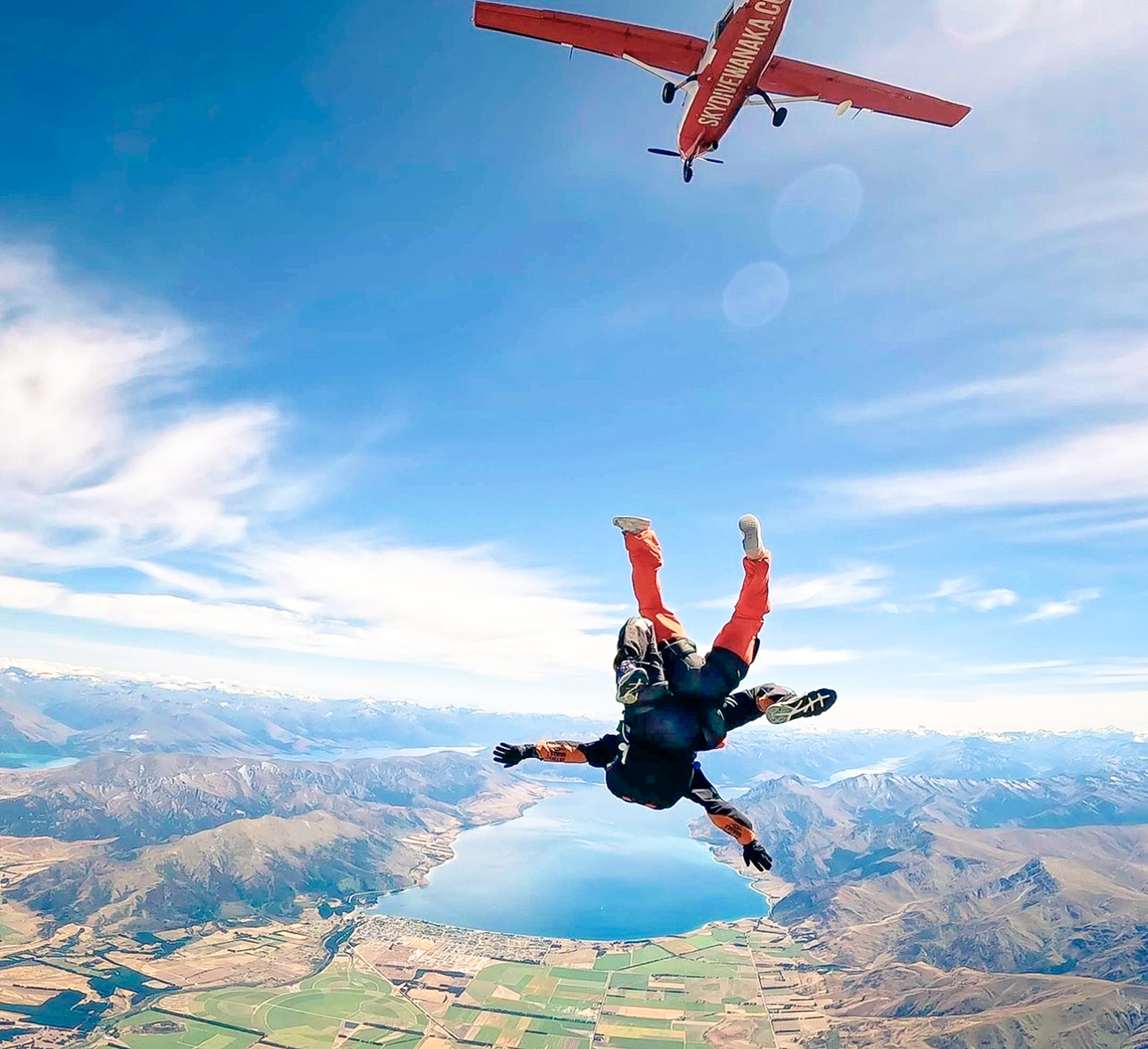 Traveller skydiving over Lake Wanaka in Wanaka, New Zealand