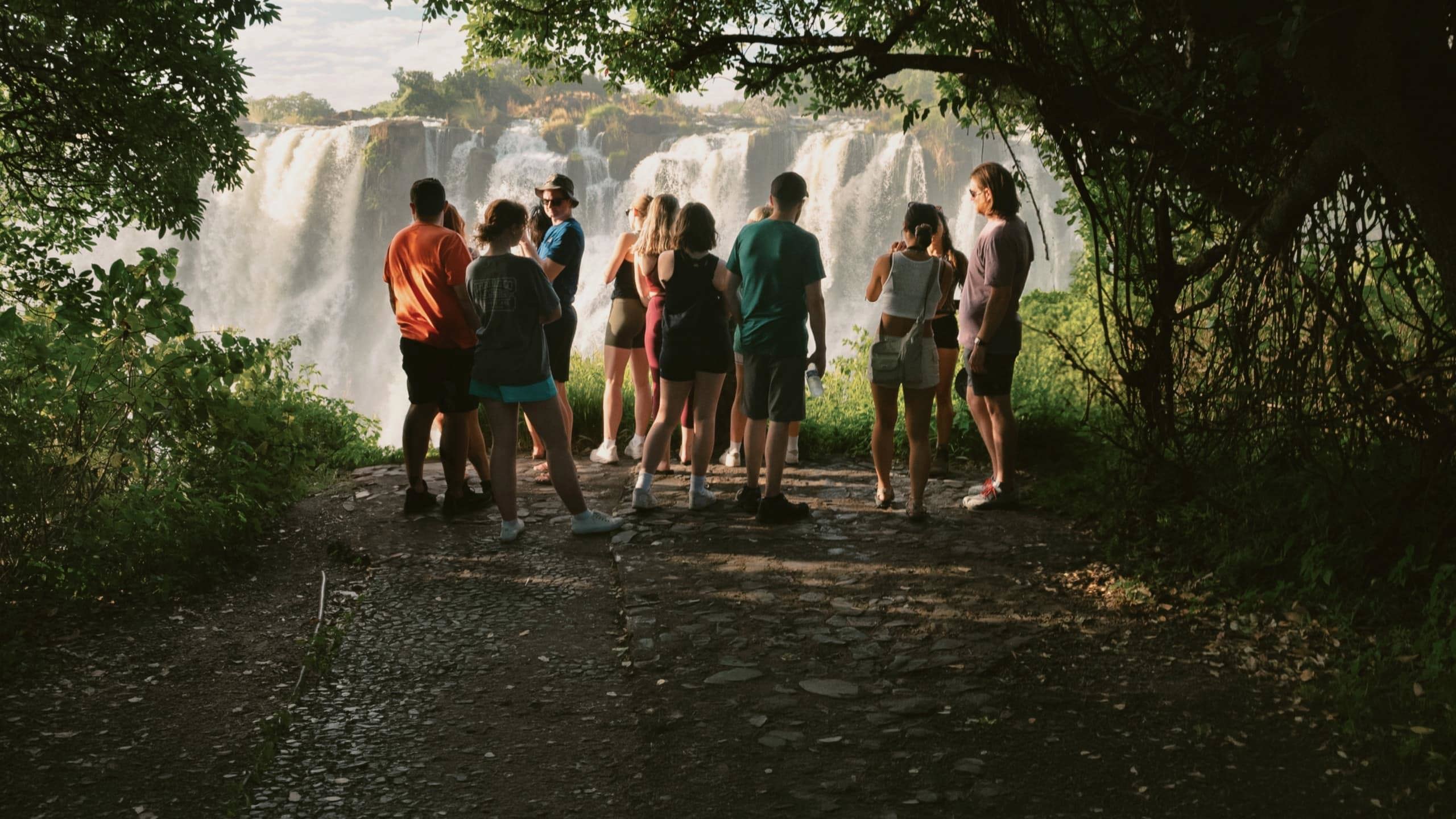 Contiki travellers viewing Victoria Falls from a rainforest lookout on the Victoria Falls Mini Break Tour