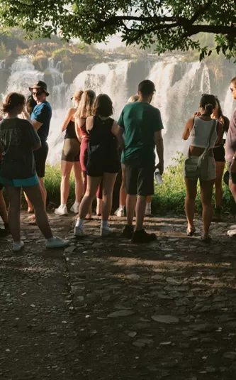 Contiki travellers viewing Victoria Falls from a rainforest lookout on the Victoria Falls Mini Break Tour