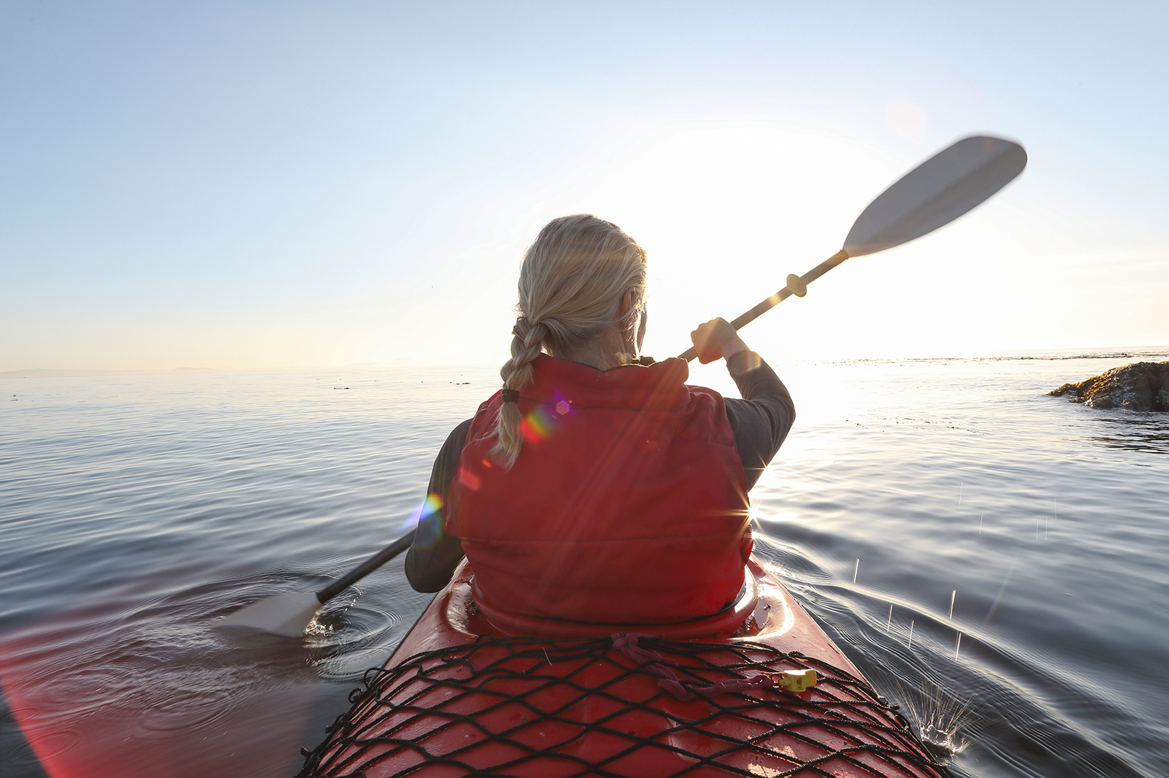 Traveller kayaking on the sea