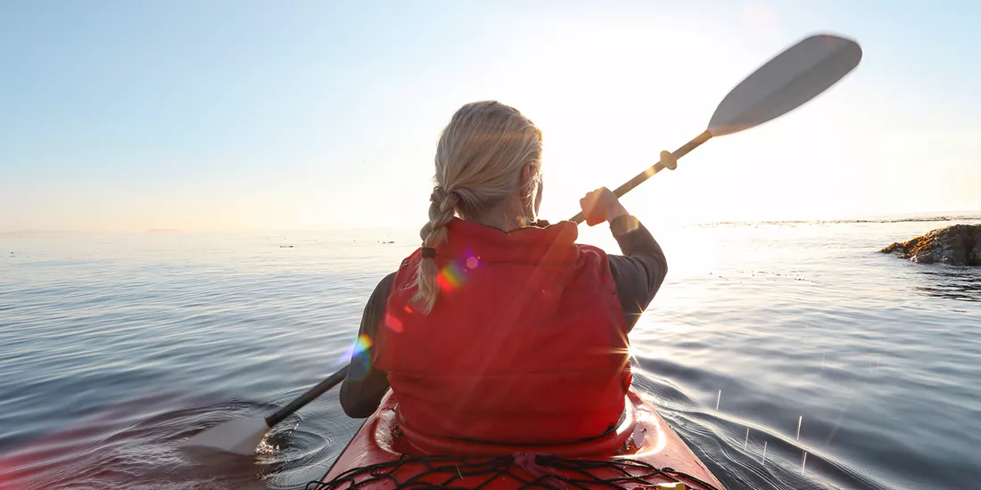 Traveller kayaking on the sea