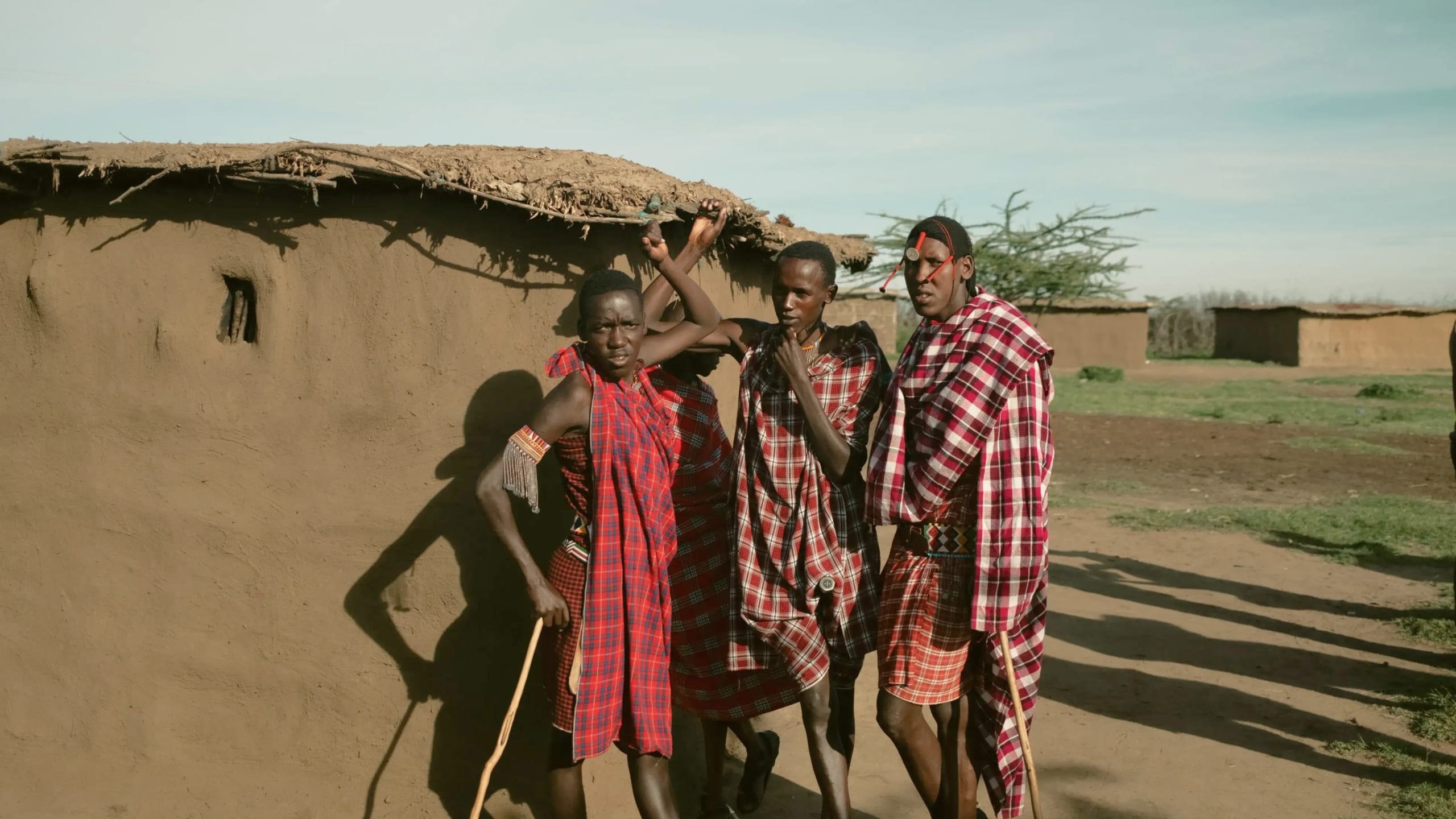 Group meet Maasai community members in a traditional village during Contiki's Kenya: Maasai Mara & Safari Tour
