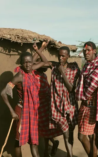 Group meet Maasai community members in a traditional village during Contiki's Kenya: Maasai Mara & Safari Tour