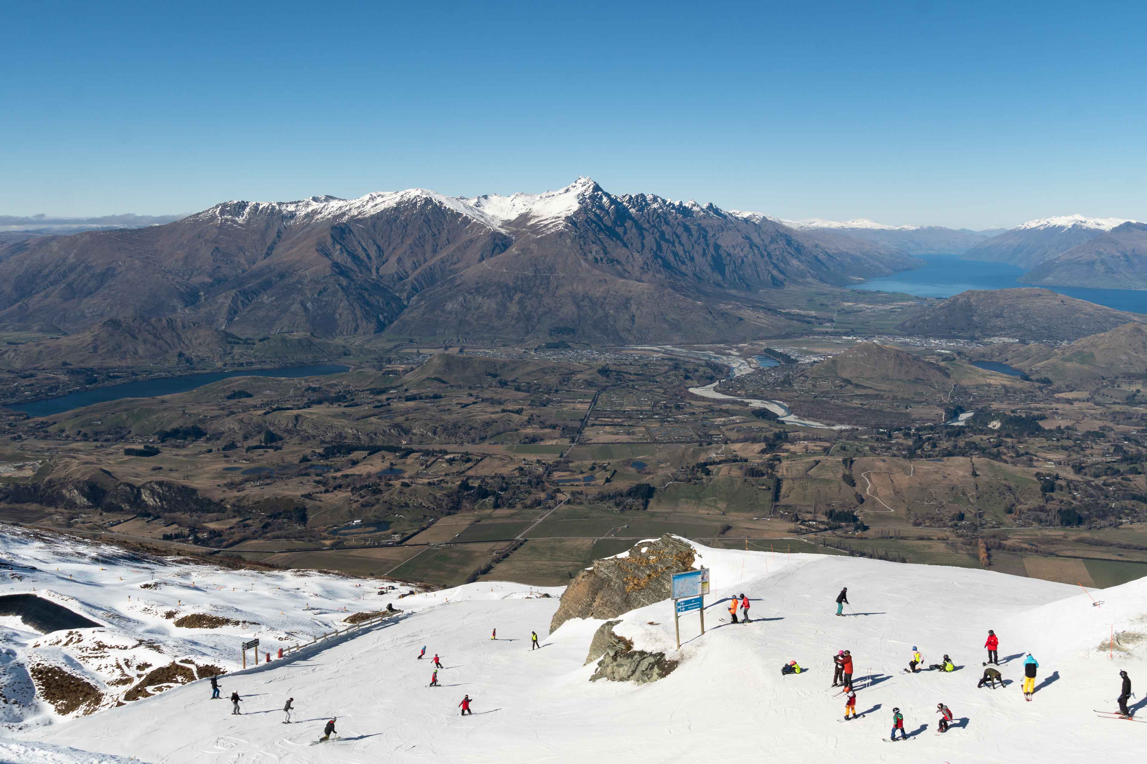 Skiers On The Slope Of The Coronet Peak Ski Resort Near Queenstown In New Zealand