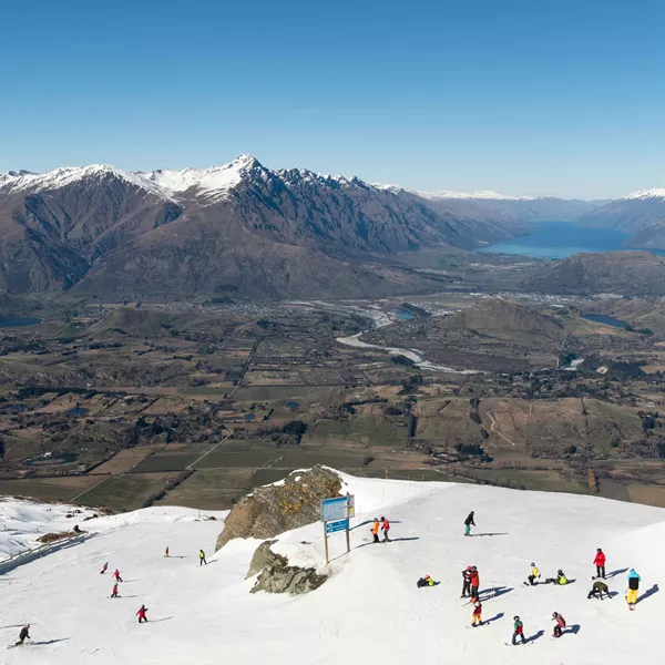 Skiers On The Slope Of The Coronet Peak Ski Resort Near Queenstown In New Zealand