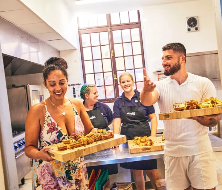 Travellers and Staff preparing a sustainable meal at the Contiki Château in Beaujolais wine region in France