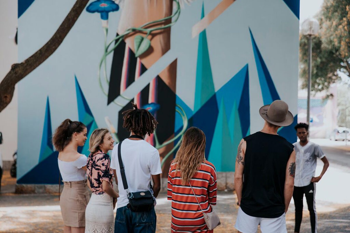People Looking At A Grafitti in Portugal