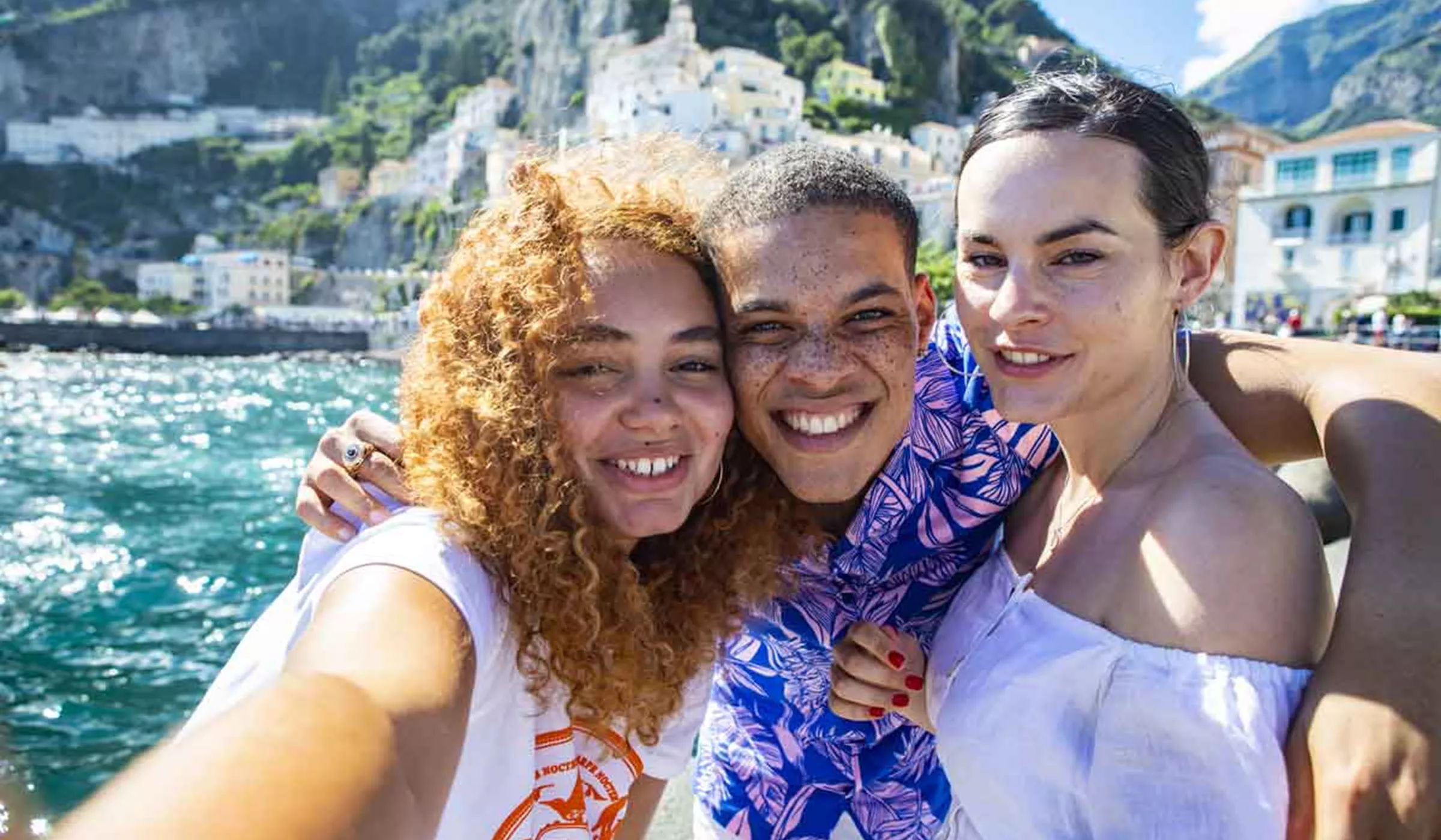 Trio of travelers taking selfie on Amalfi Coast, Italy