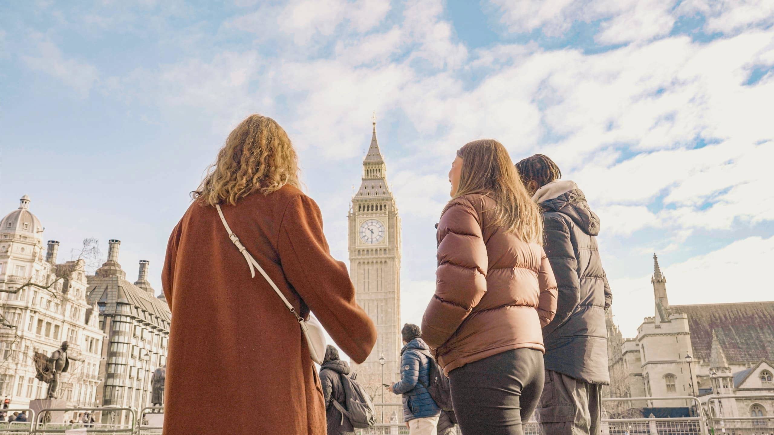 Travellers standing in front of Big Ben and the Palace of Westminster in London, England, on the Contiki Great Britain & Ireland 35 to 45 Tour