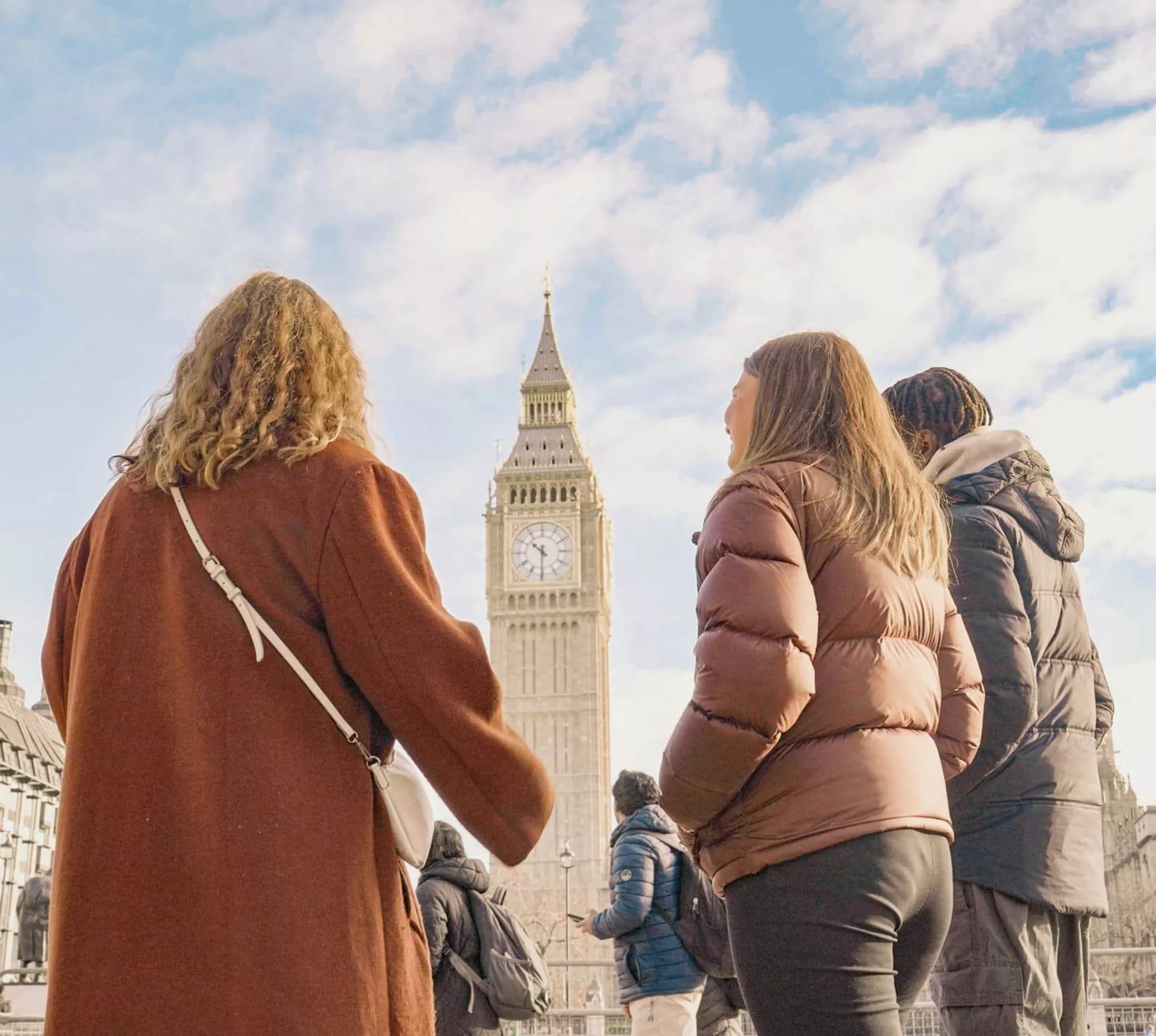 Travellers standing in front of Big Ben and the Palace of Westminster in London, England, on the Contiki Great Britain & Ireland 35 to 45 Tour
