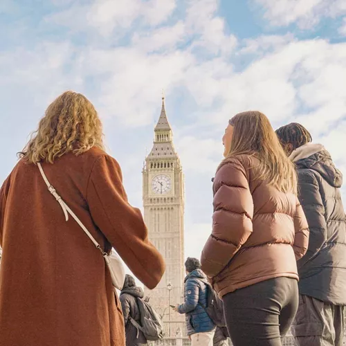 Travellers standing in front of Big Ben and the Palace of Westminster in London, England, on the Contiki Great Britain & Ireland 35 to 45 Tour
