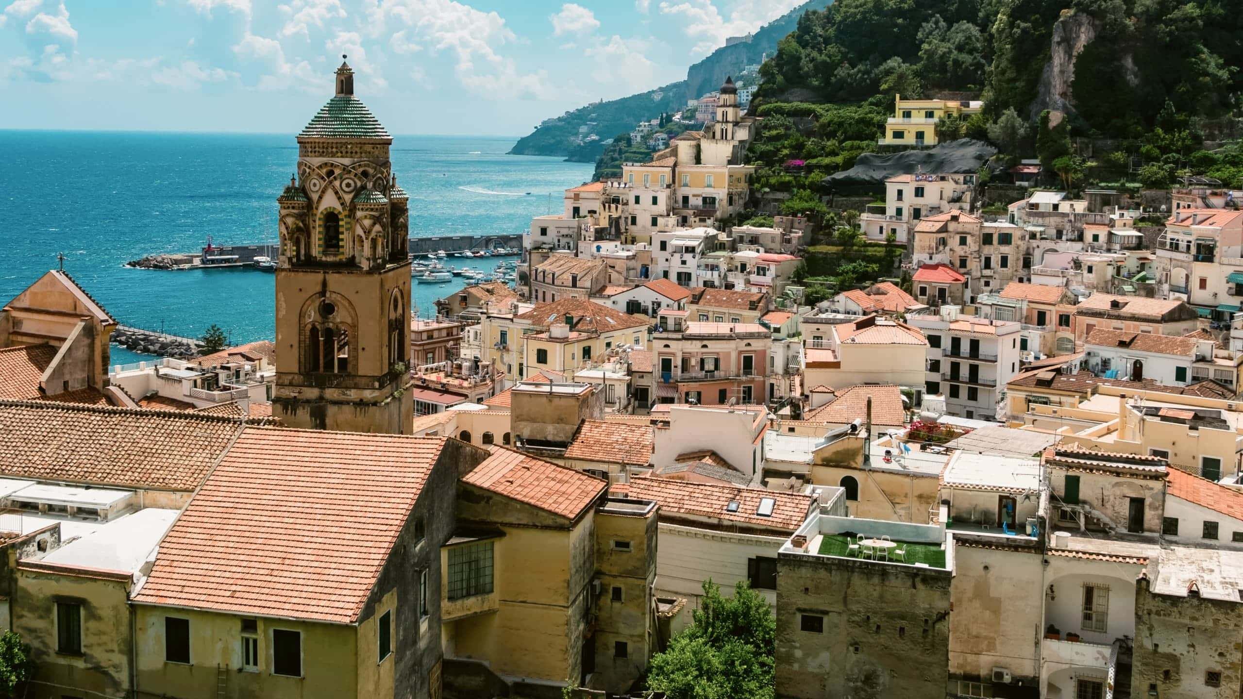 View over Amalfi, Italy, with the Cathedral of St. Andrew, colourful hillside buildings and the Tyrrhenian Sea.