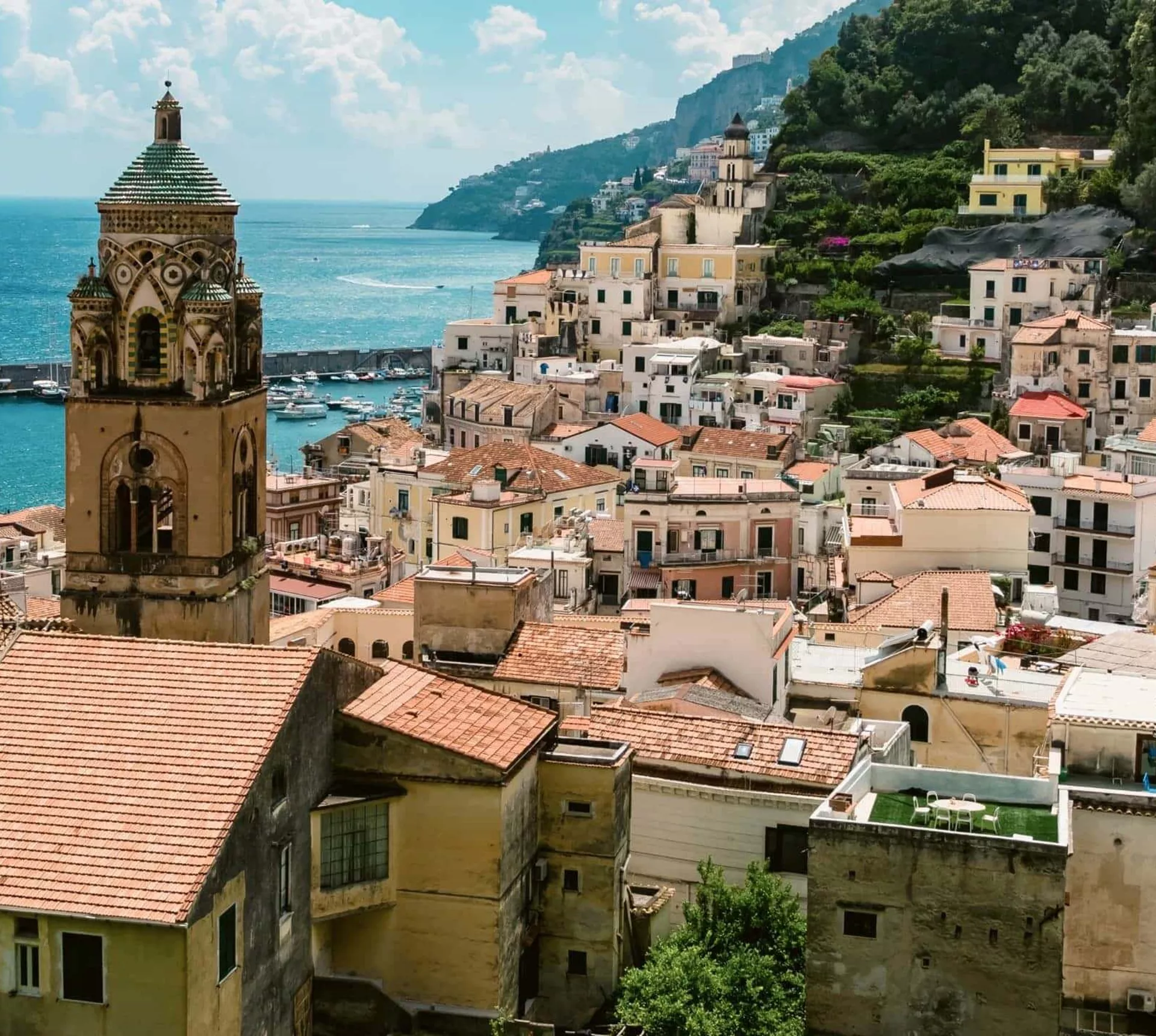 View over Amalfi, Italy, with the Cathedral of St. Andrew, colourful hillside buildings and the Tyrrhenian Sea.