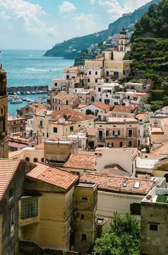 View over Amalfi, Italy, with the Cathedral of St. Andrew, colourful hillside buildings and the Tyrrhenian Sea.
