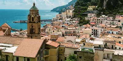 View over Amalfi, Italy, with the Cathedral of St. Andrew, colourful hillside buildings and the Tyrrhenian Sea.