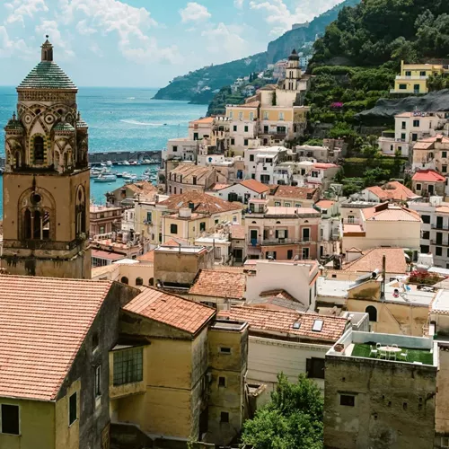 View over Amalfi, Italy, with the Cathedral of St. Andrew, colourful hillside buildings and the Tyrrhenian Sea.
