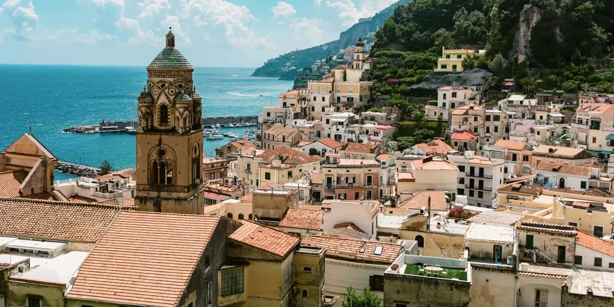 View over Amalfi, Italy, with the Cathedral of St. Andrew, colourful hillside buildings and the Tyrrhenian Sea.
